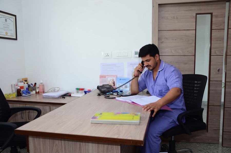 Nurse providing bedside care to a patient in the ward